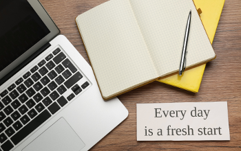 Laptop and notebook on a table